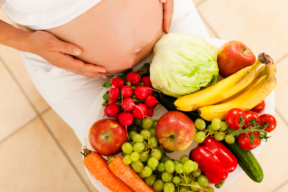 Pregnancy-and-nutrition-pregnant-woman-with-a-bowl-of-fruit-and-vegetables-on-her-lap.jpg